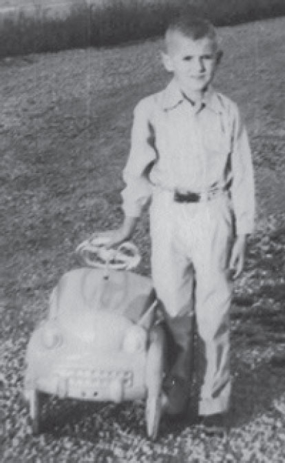 Young Mike Yager with pedal car